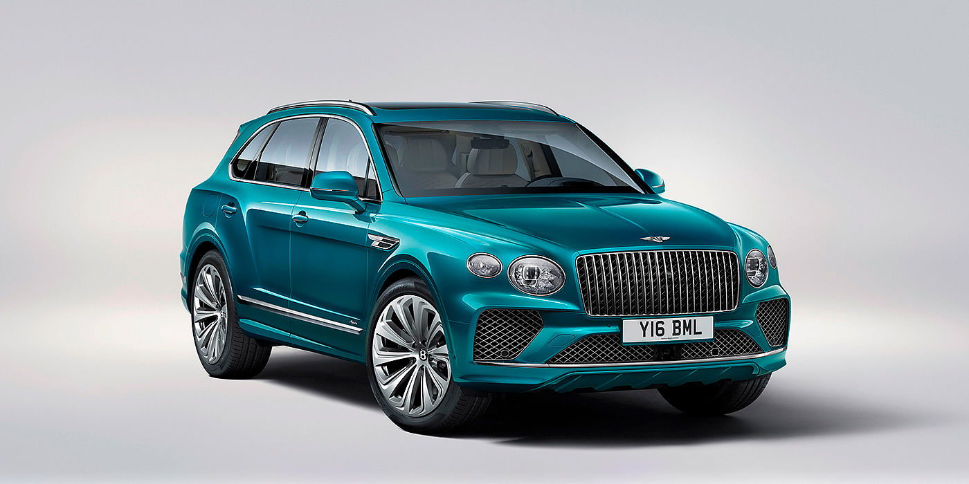 Bentley Warszawa Bentley Bentayga Azure front three-quarter view, featuring a fluted chrome grille with a matrix lower grille and chrome accents in Topaz blue paint.
