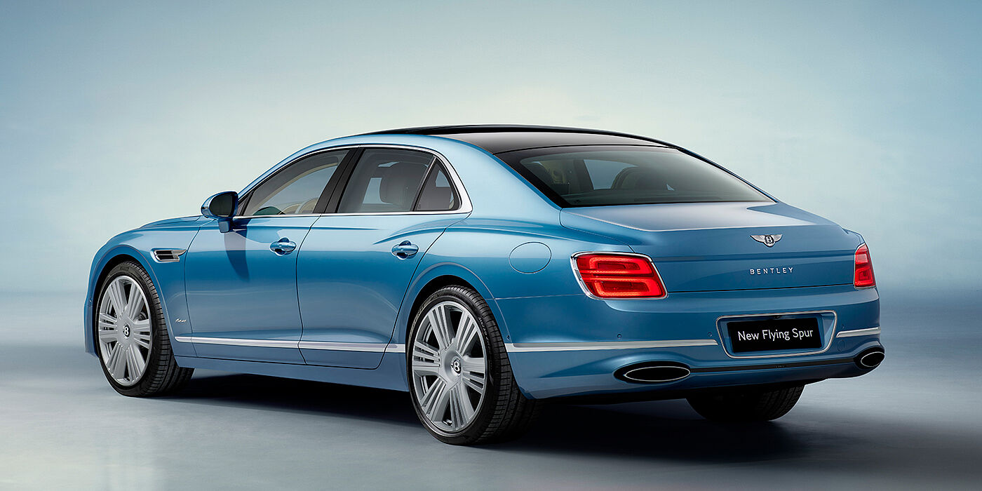 Bentley Warszawa New Bentley Flying Spur Azure sedan rear view in Light windsor blue by Mulliner paint with 22 inch Azure wheels and chrome exterior details