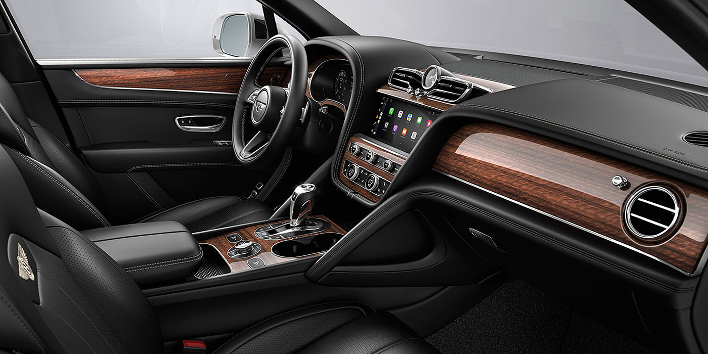 Bentley Warszawa Bentley Bentayga interior with a Crown Cut Walnut veneer, view from the passenger seat over looking the driver's seat.