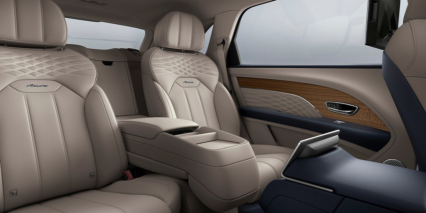 Bentley Warszawa Bentley Bentayga EWB Azure interior view for rear passengers with Portland hide featuring Azure Emblem in Imperial Blue contrast stitch.