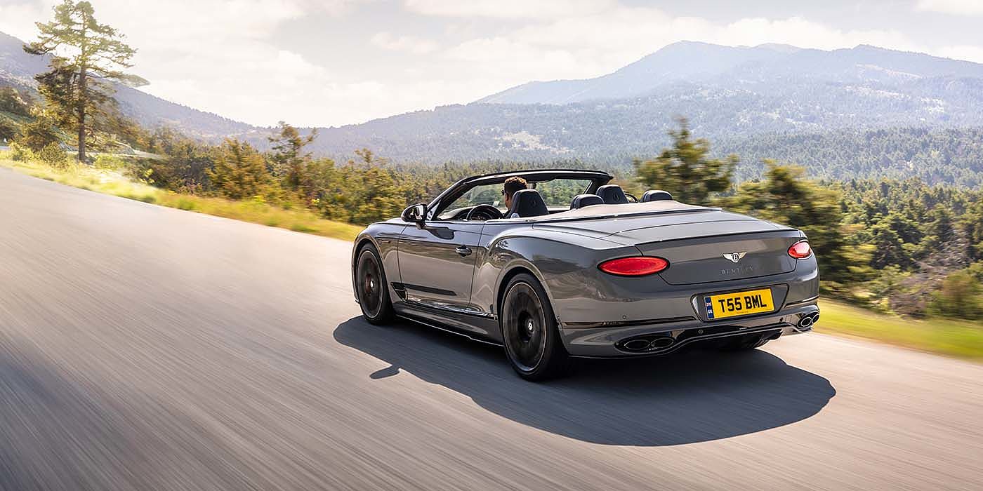 Bentley Warszawa Bentley Continental GTC S convertible in Cambrian Grey paint rear 34 dynamic driving