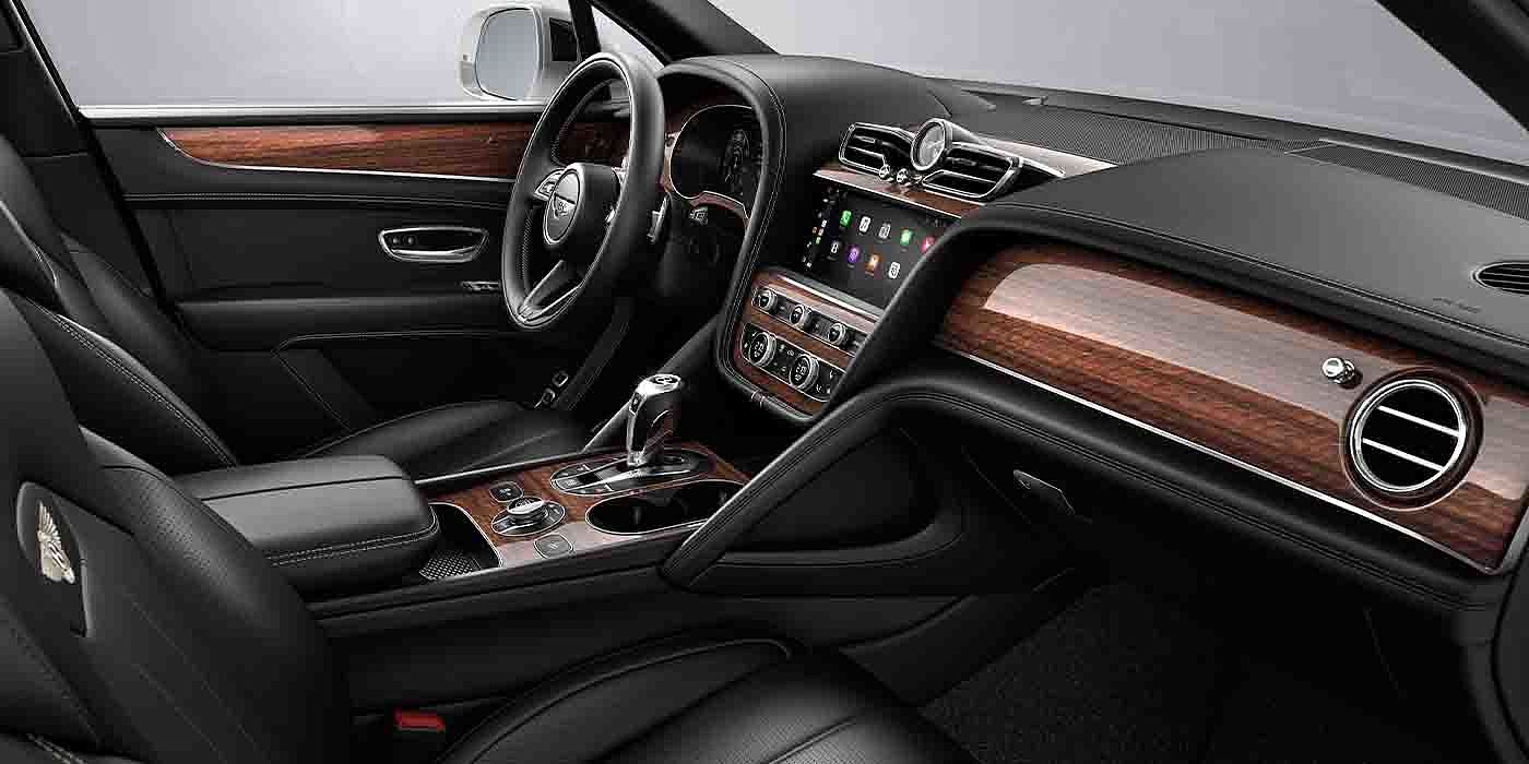 Bentley Warszawa Bentley Bentayga EWB interior with a Crown Cut Walnut veneer, view from the passenger seat over looking the driver's seat.