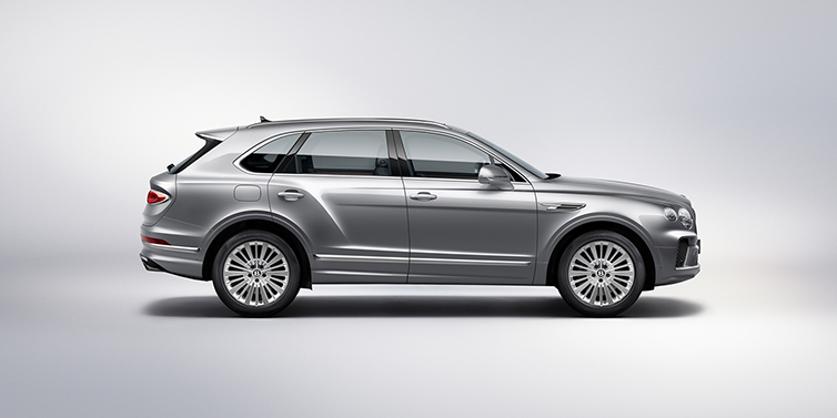 Bentley Warszawa Bentley Bentayga SUV side profile in Moonbeam silver paint against white background featuring 21 inch 5 spoke wheels