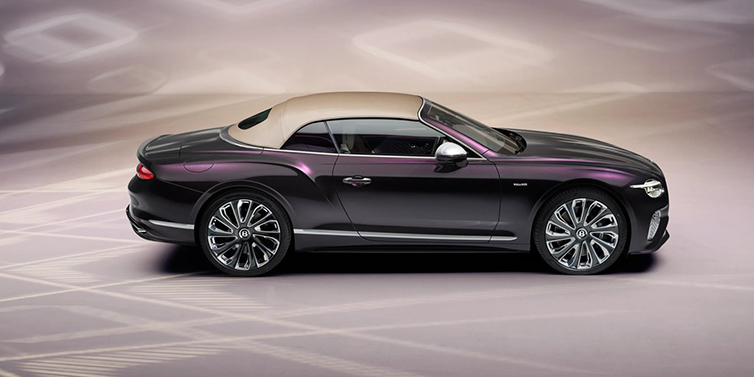 Bentley Warszawa Bentley Continental GTC Mulliner convertible in profile with hood up, in Tanzanite Purple paint and 22 inch Mulliner painted and polished wheels