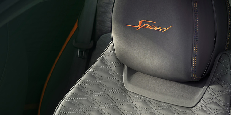 Bentley Warszawa Bentley Continental GT Speed coupe seat detail in Gravity Grey hide and Speed emblem in Mandarin by Mulliner coloured embroidery