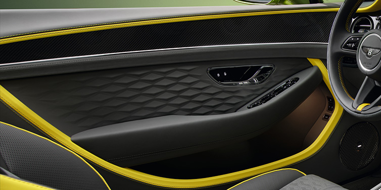 Bentley Warszawa Bentley Continental GTC Speed convertible interior door details featuring Gravity Grey and Cyber Yellow by Mulliner hides and high gloss carbon fibre veneer