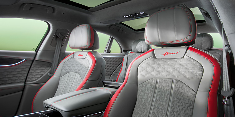 Bentley Warszawa Bentley Flying Spur Speed sedan interior showing front and rear seats in Hotspur red and Gravity Grey hides, with Speed seat emblems