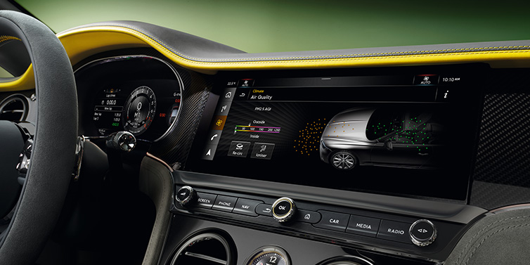 Bentley Warszawa Bentley Continental GTC Speed convertible front interior centre console with MMI screen showing Air Quality visualisation surrounded by Cyber Yellow by Mulliner and Gravity Grey hides and high gloss carbon fibre veneer