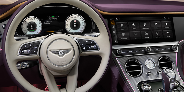 Bentley Warszawa Bentley Continental GTC Mulliner convertible steering wheel and drivers screens surrounded by Damson purple and Linen hides